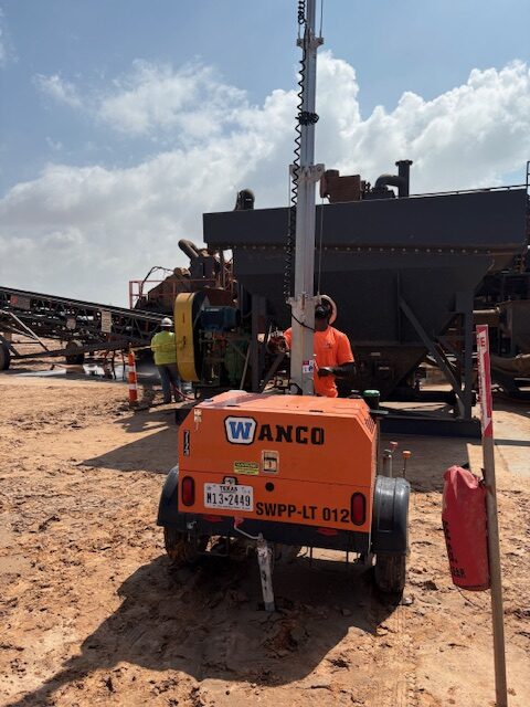 setting up a light tower on a job site